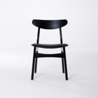 A black wooden chair with a curved backrest and simple, modern design, shown against a plain white background.