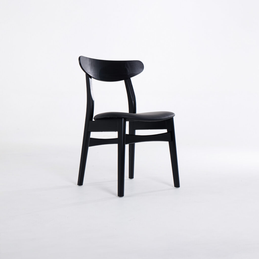 A simple black wooden chair with a curved backrest and four straight legs, set against a plain white background.