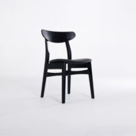A simple black wooden chair with a curved backrest and four straight legs, set against a plain white background.